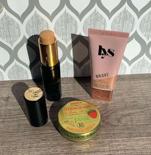 Lancome Teint Idole Stick Foundation in 410 Bisque W, Smith's Strawberry Lip Balm, and LYS Aim High Liquid Highlighter in Brave