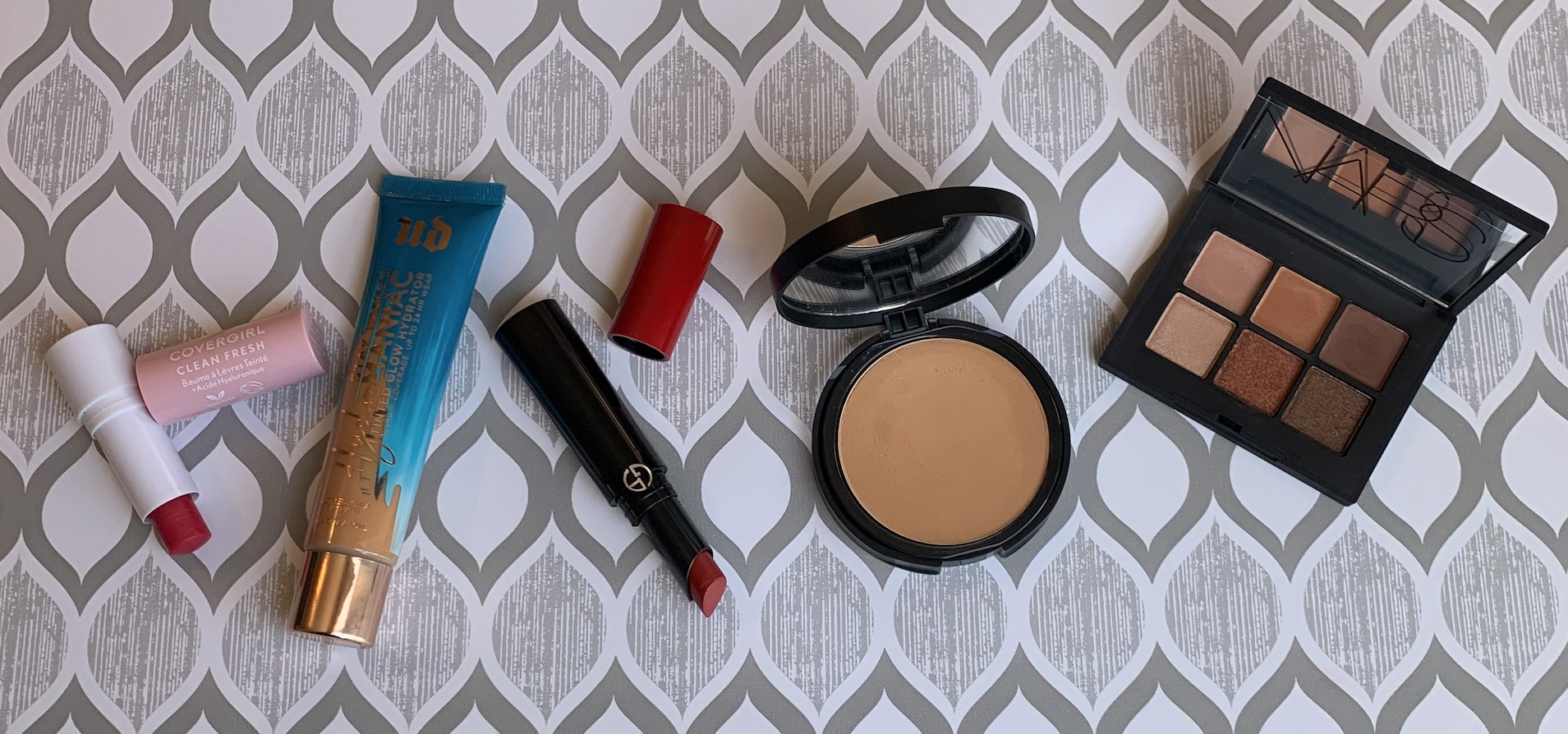 NARS Copper Mini Voyageur Eyeshadow Palette, bareMinerals Bare Pro 16HR Powder Foundation in Medium 35 Warm, Armani Lip Power Long Lasting Satin Lipstick in 400, Urban Decay Hydromaniac Tinted Glow Hydrator in 60 Medium Dark, and Covergirl Clean Fresh Tinted Lip Balm in Red Maple Bloom Swatches